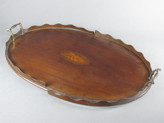 An Edwardian oval inlaid mahogany twin handled tea tray 23" x  15"