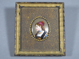 A "Flemish" enamelled plaque of a bonnetted lady 2 1/2" oval