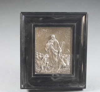 A rectangular embossed silver plated plaque decorated a shepherd  8" x 10" contained in an ebony frame