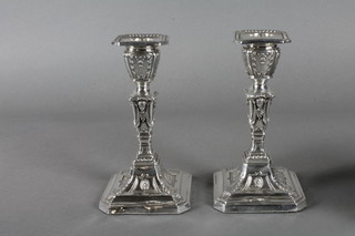 A pair of Victorian embossed silver candlesticks with detachable  sconces raised on square feet, Sheffield 1899 6"   ILLUSTRATED