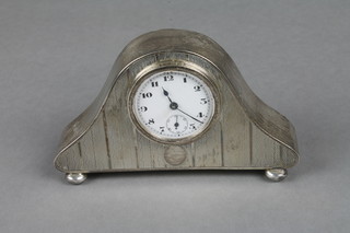 A bedroom timepiece with enamelled dial and Arabic numerals contained in a silver Admiral's hat shaped case, Chester, marks  rubbed 4"  ILLUSTRATED
