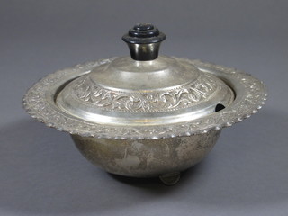 An Eastern embossed white metal circular jar and cover 6 1/2"
