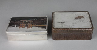 A handsome Oriental silver and niello cigarette box, the lid decorated a gateway 6" together with an Oriental woven cane box  with silver lid decorated a landscape 5 1/2"   ILLUSTRATED