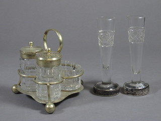 A pair of cut glass specimen vases with silver bases 5" and a 3 piece condiment set with silver plated frame