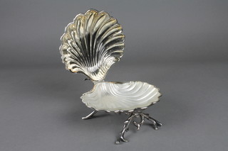 A scallop shaped silver plated butter dish and a spirit measure
