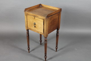 A Victorian mahogany pot cupboard with three-quarter gallery raised on turned supports 16 1/2"w x 32"h x 16"d