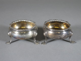 A pair of Georgian silver salts raised on hoof feet, marks rubbed 3 1/2 ozs
