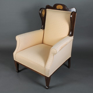 An Edwardian inlaid mahogany show frame armchair with upholstered seat and back, raised on square tapering supports