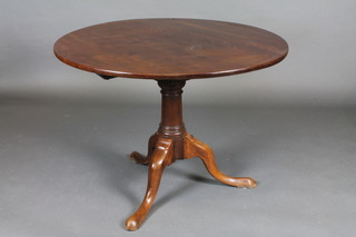 A circular 19th Century snap top tea table with bird cage action, raised on a gun barrel and tripod base 38"w x 28 1/2"h