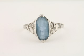 A lady's attractive white gold dress ring set an oval aquamarine with diamonds to the shoulders