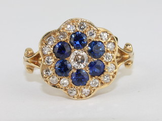A lady's 18ct yellow gold cluster dress ring set 6 sapphires surrounded by diamonds