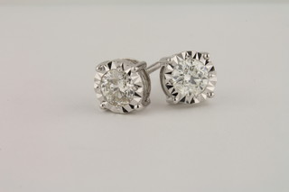A pair of 18ct white gold solitaire ear studs, approx 1.02ct