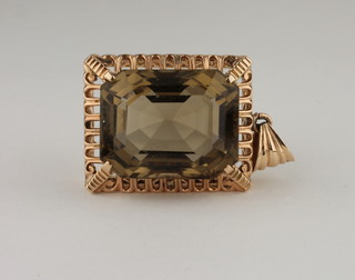 A rectangular smoky quartz pendant within a 9ct gold mount