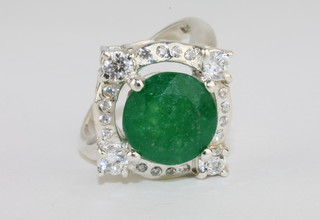 A silver dress ring set a circular cut green stone approx 4ct supported by diamonds