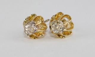 A pair of 18ct yellow gold earrings each set a diamond
