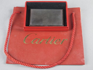 A Cartier stainless steel card case, boxed and complete with carrier bag