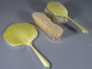 An Art Deco 3 piece silver and yellow enamelled backed dressing table set with hand mirror, hair brush and clothes brush,  Birmingham 1932
