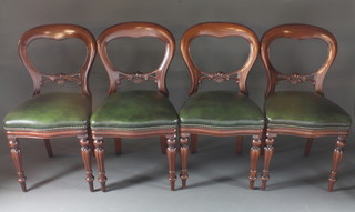 A set of 4 Victorian style mahogany balloon back dining chairs  with shaped mid rails and upholstered seats, raised on turned  supports