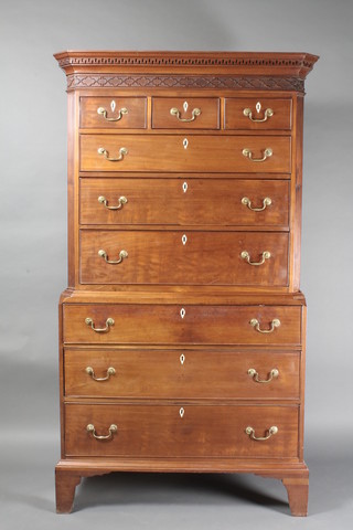 A Georgian mahogany chest on chest with fluted canted corners, the moulded cornice with Grecian key and blind fret work frieze,  the upper section fitted 3 short drawers above 3 long drawers, the  base fitted 3 long drawers with ivory escutcheons and brass swan  neck drop handles, raised on bracket feet 40"w x 21"d x 74"h   ILLUSTRATED