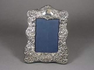A modern embossed silver easel photograph frame 9" x 7"