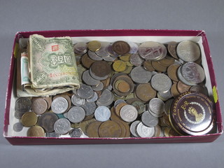 A collection of various coins and a small collection of bank notes and stamps