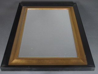 A pair of rectangular bevelled plate wall mirrors contained in black and gilt frames 27" x 34 1/2"