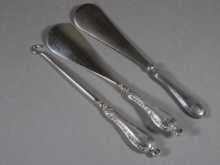 2 silver handled shoe horns and a button hook