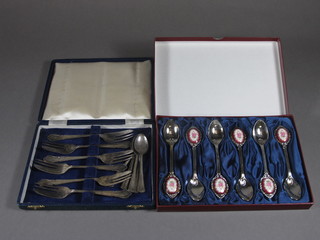 A set of 6 silver plated pastry forks and a set of 6 silver plated teaspoons, a set of 6 silver plated teaspoons with floral porcelain  panels cased