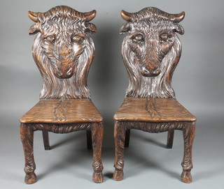 A pair of heavily carved Victorian mahogany hall chairs  decorated Buffalo  ILLUSTRATED