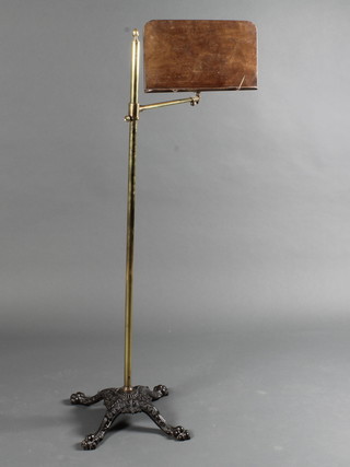 A Victorian brass and iron adjustable music stand
