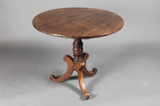 A Victorian circular snap top mahogany tea table raised on a turned column with outswept supports 32"diam. x 26 1/2"h
