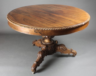 A Victorian Anglo Indian carved rosewood pedestal breakfast  table, raised on a carved column and tripod base 46"w x 30"h  ILLUSTRATED