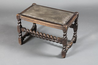 A rectangular carved oak stool raised on spiral turned and block supports 23"w x 14"d x 16"h