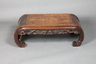 An Oriental carved hardwood scroll shaped occasional table 37"w  x 17 1/2"d x 13"h