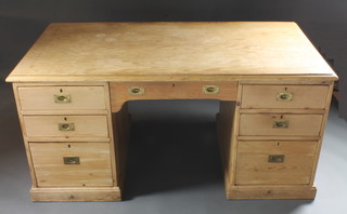A pine kneehole pedestal desk fitted 1 long and 6 short drawers  with brass counter sunk handles 62"w x 33"d x 28 1/2h