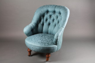 A Victorian tub back chair upholstered in blue buttoned material