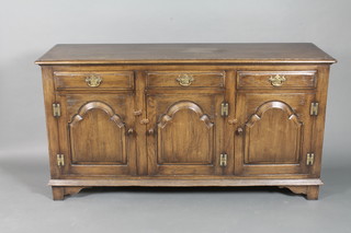 An oak dresser base fitted 3 long drawers above a triple cupboard raised on bracket feet 60"w x 19"d x 32"h