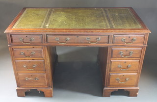 A Victorian mahogany kneehole pedestal desk with inset tooled leather writing surface above 1 long and 8 short drawers with  brass swan neck drop handles, raised on bracket feet 47"w x  26"d x 29"h