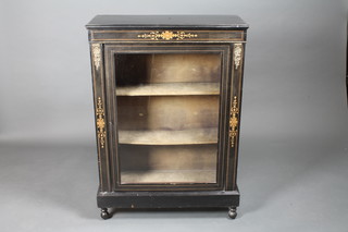 A Victorian ebonised pier cabinet, the shelved interior enclosed  by glazed panelled doors with gilt metal mounts, raised on bun  feet 30"w x 12"d x 41 1/2"h