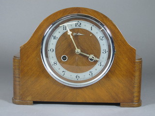 A 1940's striking mantel clock with silvered dial and Arabic  numerals contained in a walnut arch shaped case