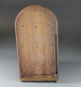 An oval wooden bagatelle game