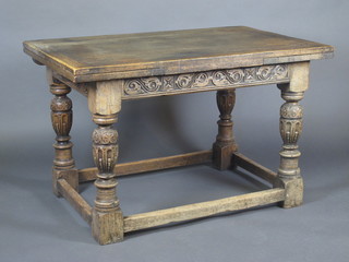 A carved oak drawleaf dining table, raised on turned and block supports 48"w x 30"h x 31 1/2"d