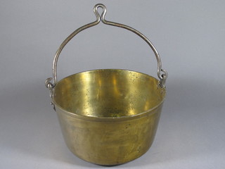 A circular brass preserving pan with iron handle 12"