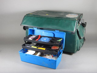 A blue plastic cantilever box containing various fishing  equipment and a green plastic fishing box containing various  equipment
