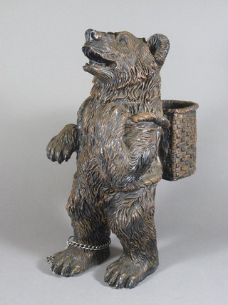A resin figure of a standing bear with panier 18"
