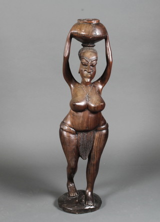 A large carved African figure of a standing lady with pot 36"