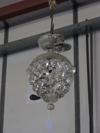A circular glass bag shaped light fitting hung glass lozenges