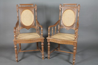 A pair of Eastern carved hardwood open arm chairs with  upholstered seats and backs raised on turned supports