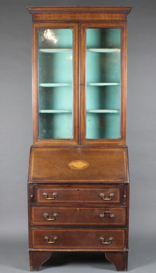 An Edwardian inlaid mahogany bureau bookcase with moulded  cornice, the interior fitted shelves enclosed by glazed panelled  doors, the fall front revealing a well fitted interior above 3 long  graduated drawers 31"w x 16 1/2"d x 78 1/2"h