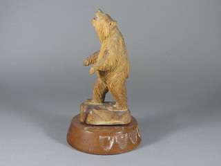 A carved wooden figure of a standing bear 12"